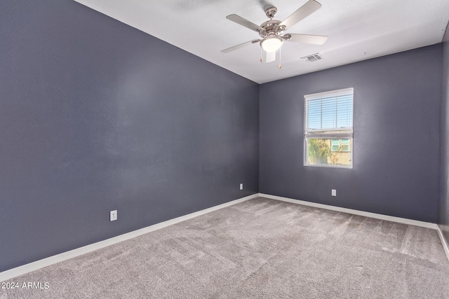 carpeted spare room with ceiling fan