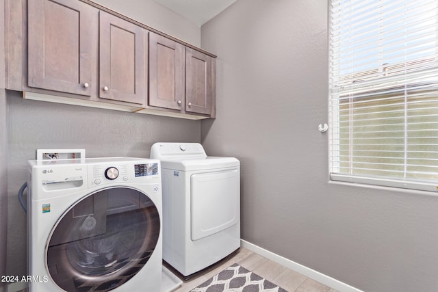 washroom with light tile patterned floors, cabinets, and independent washer and dryer