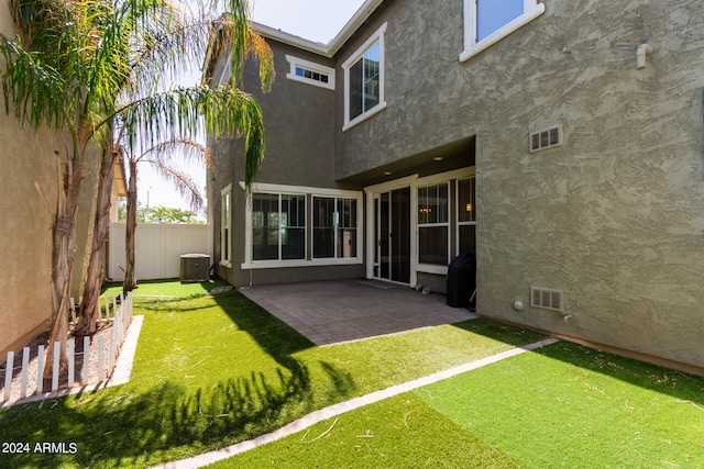 back of house with a patio, cooling unit, and a yard