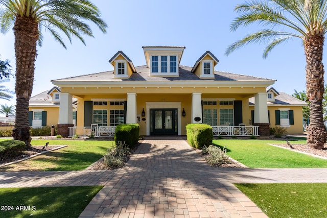 view of front facade with a front lawn and covered porch