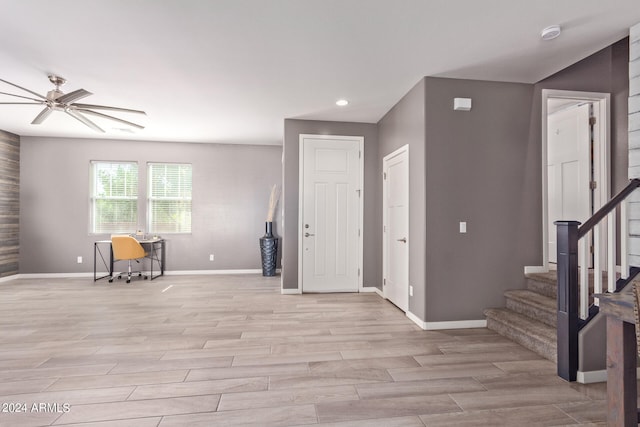 foyer entrance with light wood-type flooring and ceiling fan