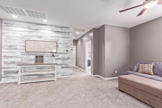 carpeted living room featuring ceiling fan