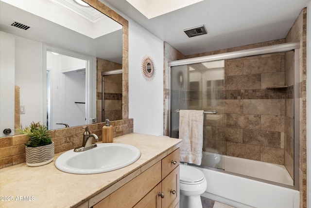 full bathroom featuring backsplash, vanity, enclosed tub / shower combo, and toilet