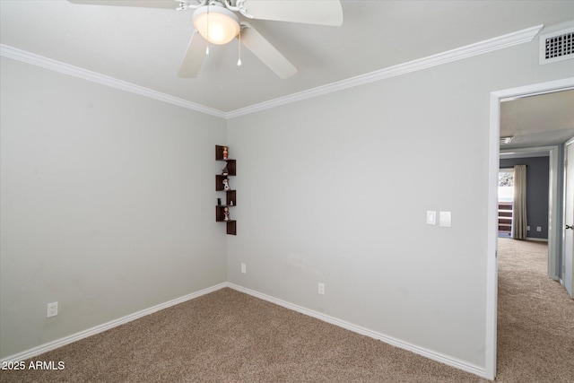 carpeted spare room with ceiling fan and crown molding