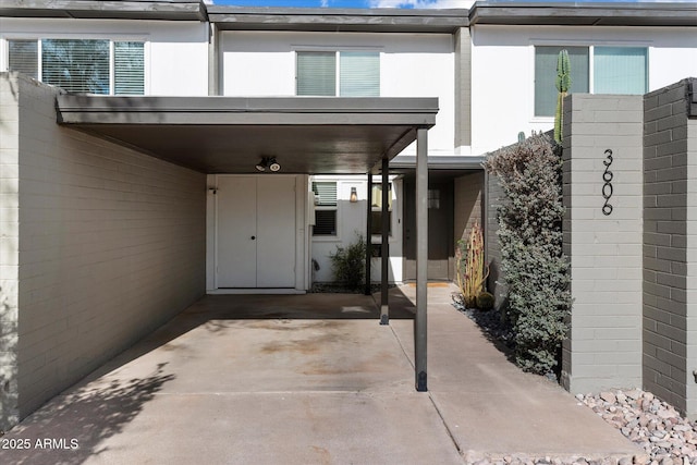 view of exterior entry with a carport