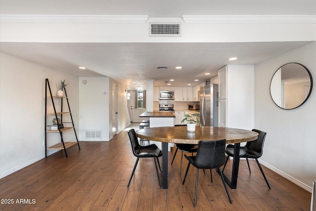 dining space with crown molding and wood-type flooring