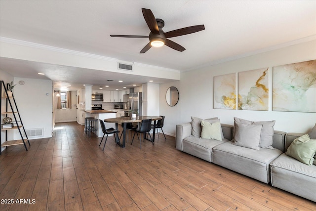 living room featuring hardwood / wood-style flooring, ceiling fan, and ornamental molding