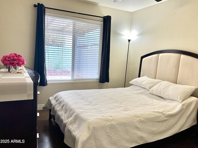 bedroom with wood finished floors and baseboards