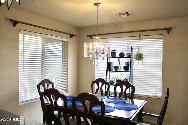 dining room with visible vents and a notable chandelier