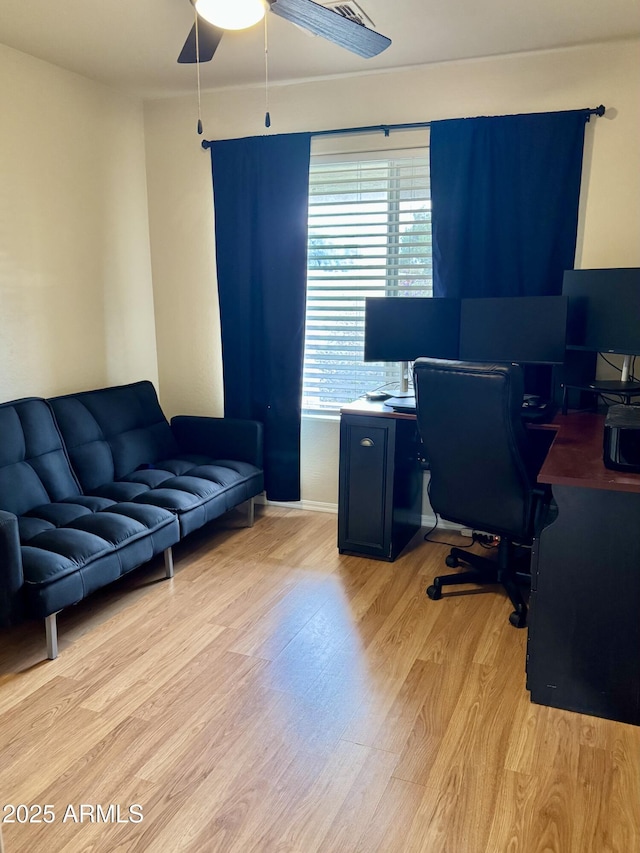 office space with light wood-style flooring and a ceiling fan