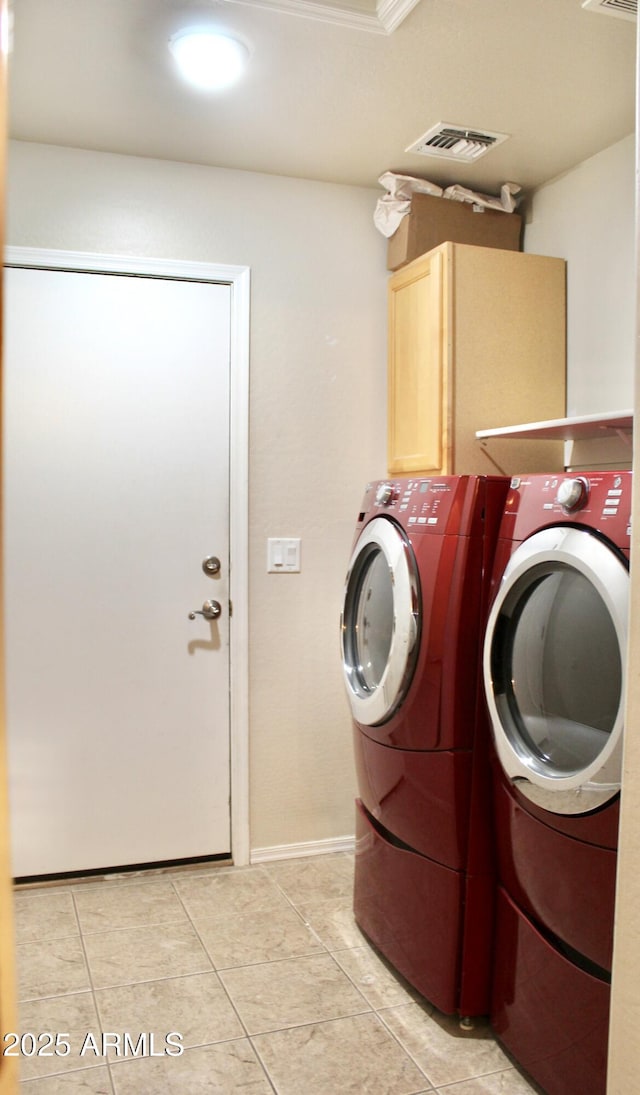 washroom with cabinet space, light tile patterned floors, visible vents, and washer and dryer