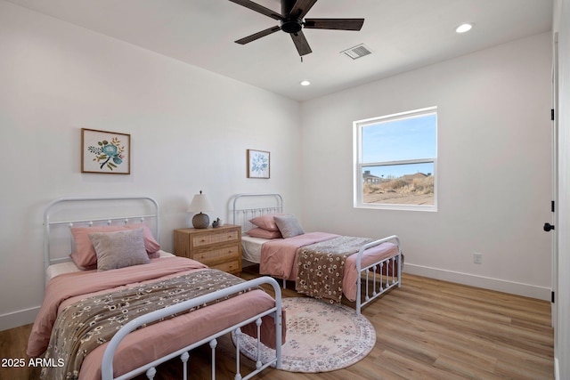 bedroom with light wood-type flooring, visible vents, baseboards, and recessed lighting