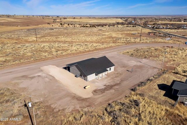 view of storm shelter with view of desert and a rural view