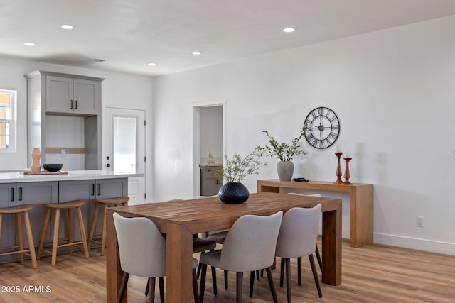 dining room featuring light wood-style floors, baseboards, and recessed lighting