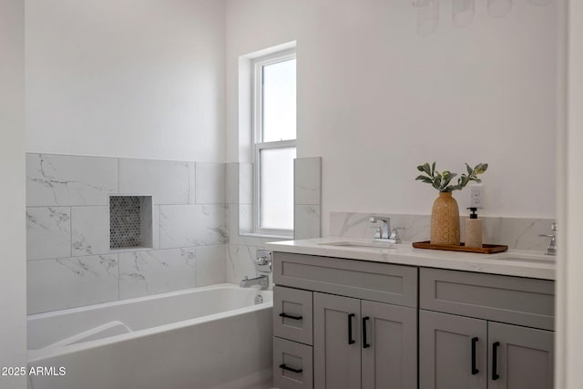 full bathroom featuring a sink, a bath, and double vanity