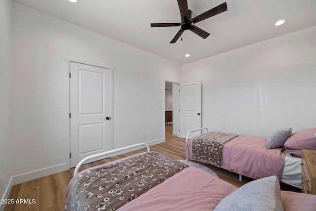 bedroom with light wood finished floors, recessed lighting, a ceiling fan, and baseboards