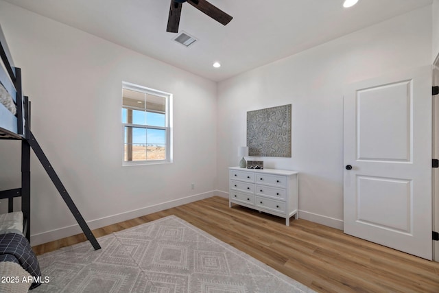 bedroom with light wood-style floors, recessed lighting, visible vents, and baseboards