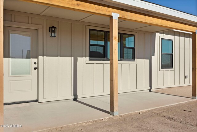 view of exterior entry featuring board and batten siding