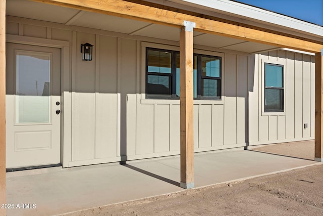 view of exterior entry with board and batten siding