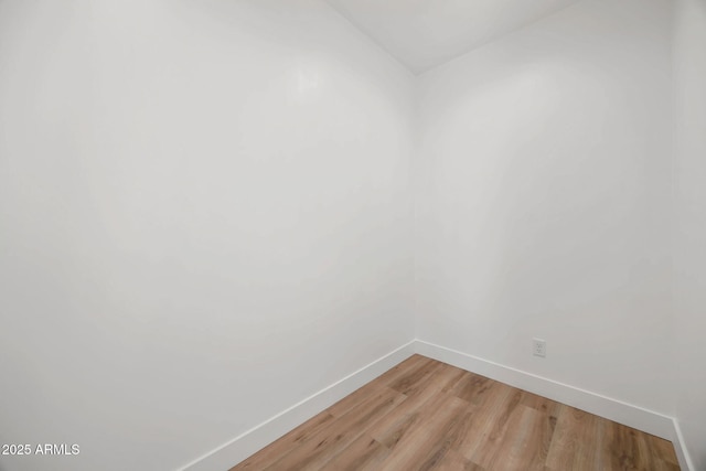 unfurnished room featuring light wood finished floors and baseboards