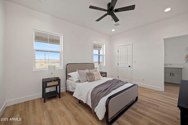 bedroom with recessed lighting, multiple windows, light wood-style flooring, and baseboards