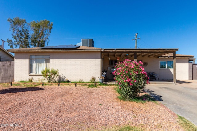 4403 N 56th Dr, Phoenix, AZ 85031 - ranch-style house with brick siding, solar panels, and central air condition unit