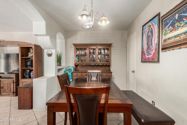 4403 N 56th Dr, Phoenix, AZ 85031 - dining room featuring light tile patterned floors, a chandelier, and a textured ceiling