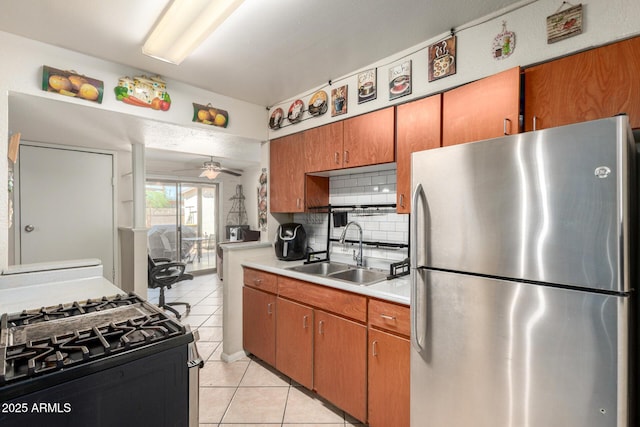 4403 N 56th Dr, Phoenix, AZ 85031 - kitchen featuring freestanding refrigerator, a sink, range with gas cooktop, light countertops, and backsplash