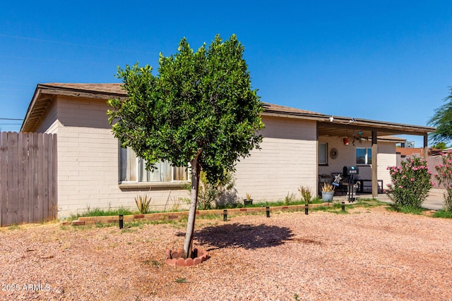 4403 N 56th Dr, Phoenix, AZ 85031 - view of side of property featuring brick siding, a patio, and roof with shingles