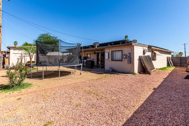 4403 N 56th Dr, Phoenix, AZ 85031 - rear view of house featuring a trampoline, ceiling fan, and a patio area
