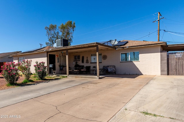 4403 N 56th Dr, Phoenix, AZ 85031 - back of house featuring solar panels, central air condition unit, and a porch