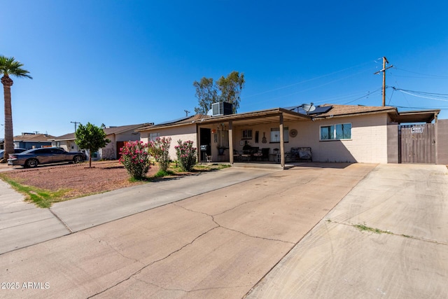 4403 N 56th Dr, Phoenix, AZ 85031 - ranch-style house featuring roof mounted solar panels, covered porch, and central AC