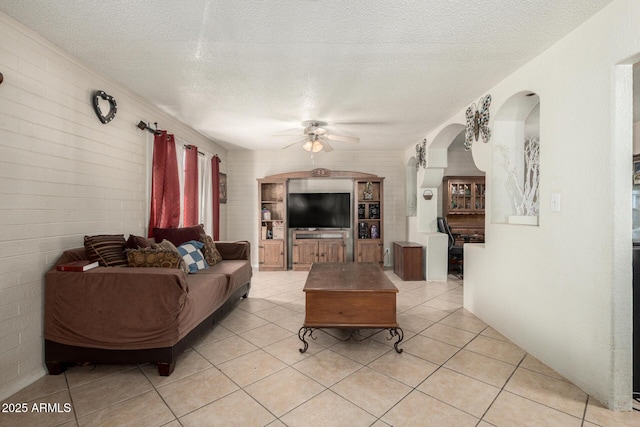 4403 N 56th Dr, Phoenix, AZ 85031 - living area with a ceiling fan, arched walkways, a textured ceiling, and light tile patterned floors