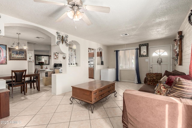 4403 N 56th Dr, Phoenix, AZ 85031 - living area featuring arched walkways, a textured ceiling, light tile patterned flooring, and ceiling fan