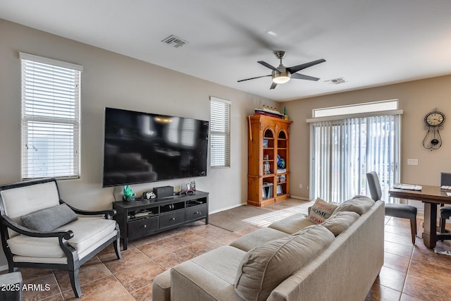 living room with ceiling fan and light tile patterned flooring