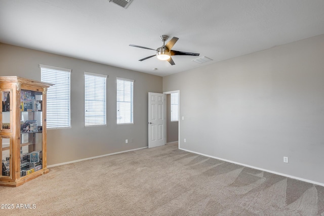 carpeted empty room featuring ceiling fan