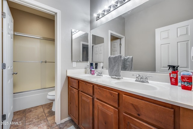 full bathroom featuring vanity, enclosed tub / shower combo, and toilet