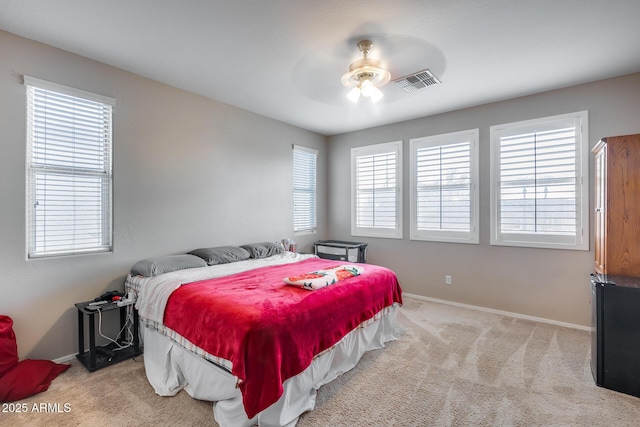 bedroom featuring ceiling fan and light carpet