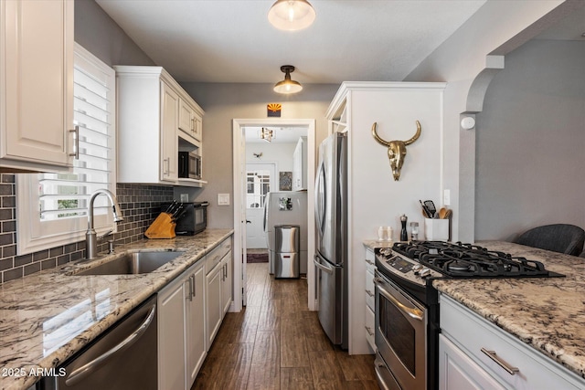 69 W Virginia Ave, Phoenix, AZ 85003 - kitchen with stainless steel appliances, a sink, dark wood-style flooring, and light stone counters