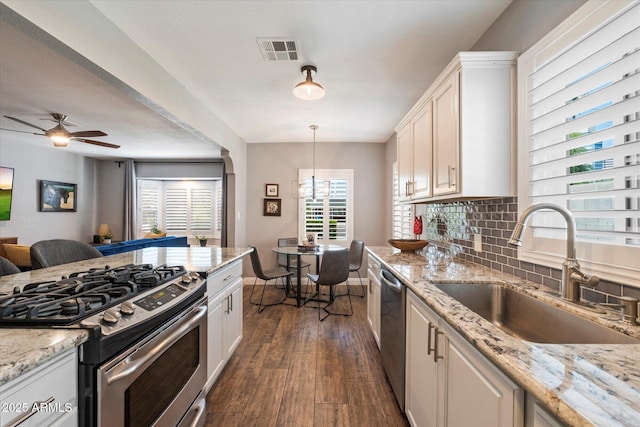 69 W Virginia Ave, Phoenix, AZ 85003 - kitchen featuring appliances with stainless steel finishes, a sink, dark wood finished floors, decorative backsplash, and open floor plan