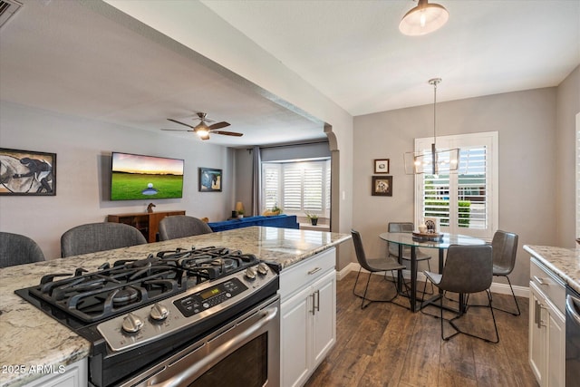 69 W Virginia Ave, Phoenix, AZ 85003 - kitchen featuring appliances with stainless steel finishes, dark wood-type flooring, white cabinets, a chandelier, and baseboards