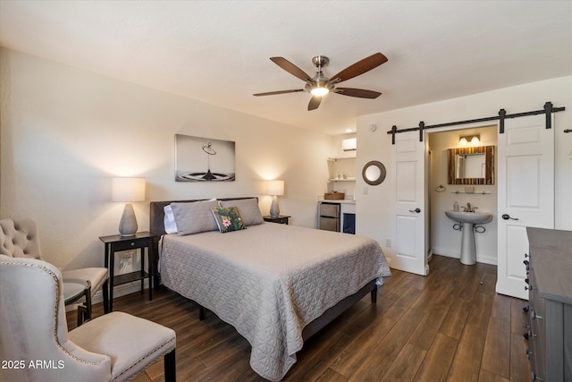 69 W Virginia Ave, Phoenix, AZ 85003 - bedroom featuring a barn door, dark wood-style flooring, a wall mounted air conditioner, and a sink