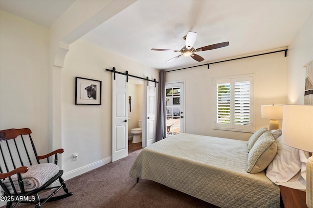 69 W Virginia Ave, Phoenix, AZ 85003 - carpeted bedroom with a barn door, baseboards, connected bathroom, ceiling fan, and arched walkways