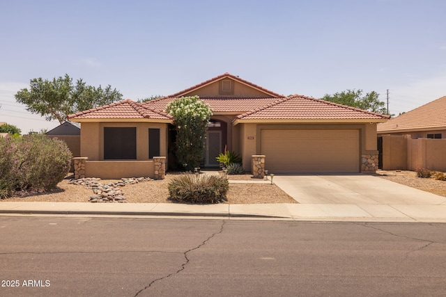 7701 E Portobello Ave, Mesa, AZ 85212 - view of front facade featuring a garage, stucco siding, concrete driveway, a tiled roof, and stone siding
