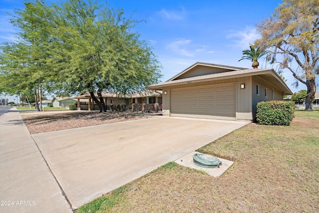 ranch-style house with a front yard and a garage