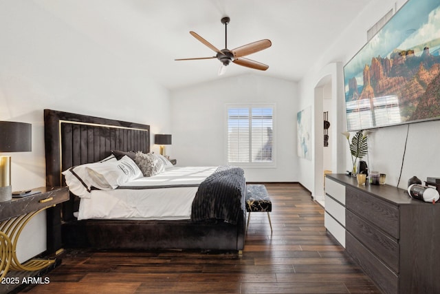 bedroom with ceiling fan, dark hardwood / wood-style flooring, and vaulted ceiling