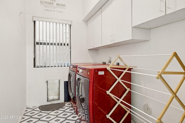 washroom with washing machine and dryer and cabinets