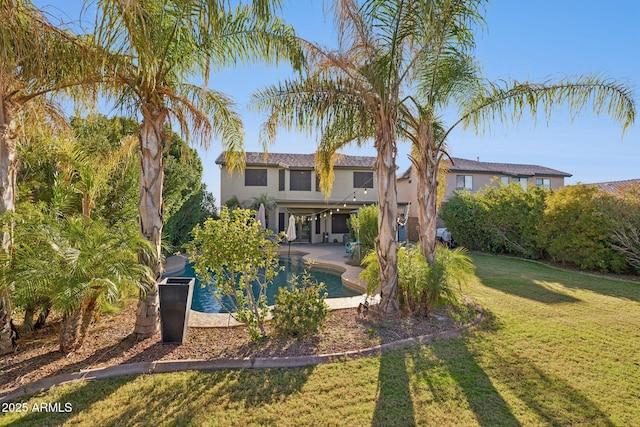 back of house featuring a patio and a lawn