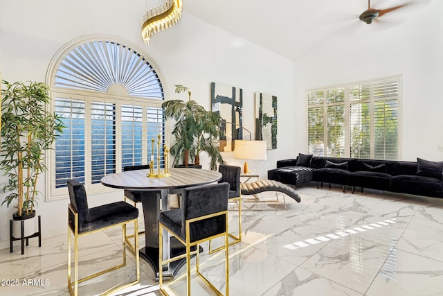 dining space featuring high vaulted ceiling and ceiling fan