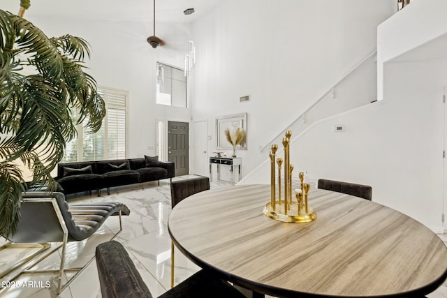 dining room featuring a towering ceiling